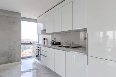 a kitchen with white cabinets and a large window at Beautiful Elegant 1BD Private Terrace Gem! #333 in Istanbul