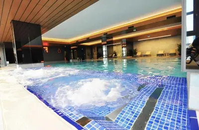 a large pool of water in a hotel at Elegant 1BD Terrace Gem PoolParking! #344 in Istanbul