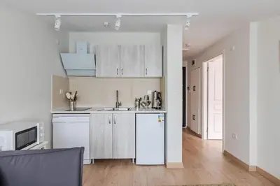 a kitchen with white cabinets and a white refrigerator at Cozy New Penthouse 1BD Nisantasi Terrace Gem! #334 in Istanbul