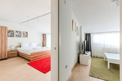 a white bedroom with a bed and a red rug at Cozy New Penthouse 1BD Nisantasi Terrace Gem! #334 in Istanbul