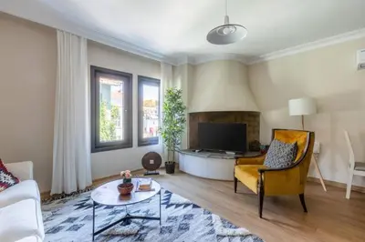 a living room with a yellow chair and a tv at Stunning Bosphorus 2BD2Bath Views Terrace! #357 in Istanbul