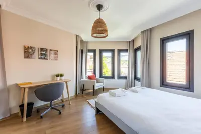 a bedroom with a bed and a desk and a chair at Gorgeous Airy 2BD2Bath Bosphorus Views! #358 in Istanbul
