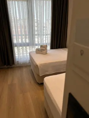a hotel room with two beds and a window at By Otel Nilüfer in Bursa