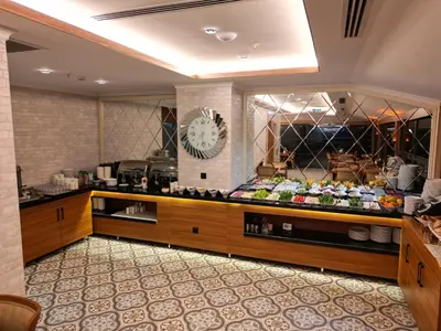 a store with a clock on the wall in a room at By Otel Nilüfer in Bursa
