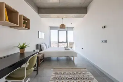 a bedroom with a bed and a desk and chairs at Gorgeous Bright Cool 1BD Residence Views! #359 in Istanbul