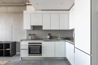 a kitchen with white cabinets and a sink at Gorgeous Bright Cool 1BD Residence Views! #359 in Istanbul