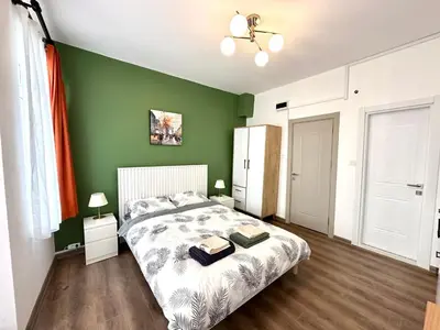 a bedroom with a bed with a green wall at Yellowhouse Room 4 in Istanbul