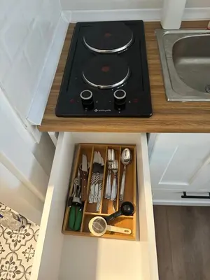 a drawer in a kitchen with a stove and utensils at Yellowhouse Room 4 in Istanbul