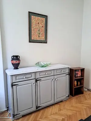 a gray cabinet with a vase on top of it at Spacious and Bright Apartment - Dirim House in Istanbul