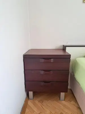 a wooden dresser in a corner of a bedroom at Spacious and Bright Apartment - Dirim House in Istanbul