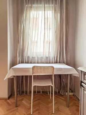 a table with a chair in front of a window at Spacious and Bright Apartment - Dirim House in Istanbul