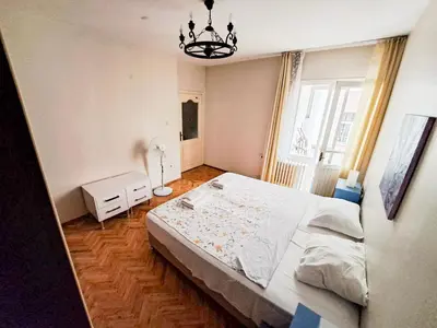 a bedroom with a large bed and a chandelier at Spacious and Bright Apartment - Dirim House in Istanbul