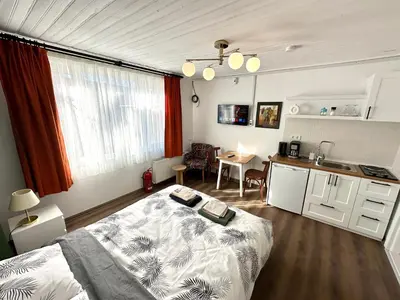 a bedroom with a bed and a kitchen in it at Yellowhouse Room 5 in Istanbul