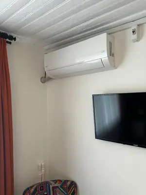 a flat screen tv hanging on a wall at Yellowhouse Room 6 in Istanbul