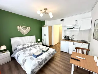 a bedroom with a bed and a table and a kitchen at Yellowhouse Room 6 in Istanbul