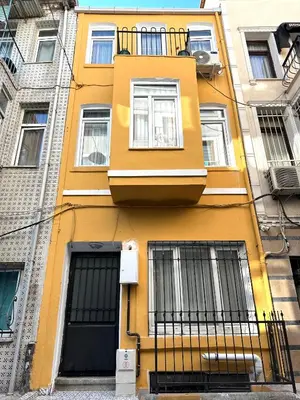 a yellow building with windows and a balcony at Yellowhouse Room 3 in Istanbul