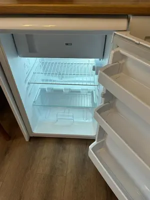 an empty refrigerator with its door open in a kitchen at Yellowhouse Room 3 in Istanbul