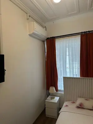 a small bedroom with a bed and a window at Yellowhouse Room 1 in Istanbul