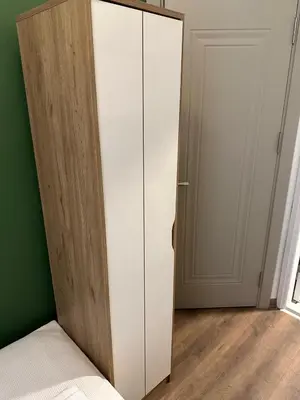 a white cabinet in a room next to a door at Yellowhouse Room 1 in Istanbul
