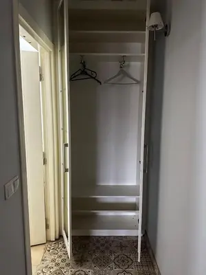 a hallway with a closet with a mirror and stairs at D&D Pansiyon in Istanbul