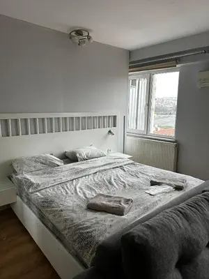 a large bed in a white room with a window at D&D Pansiyon in Istanbul