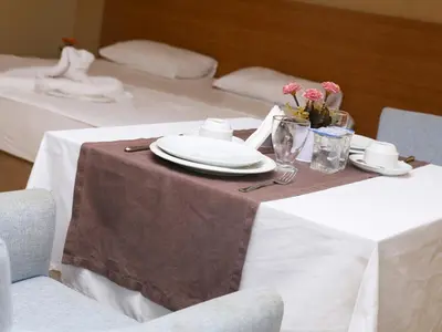 a table with a plate and flowers on it at Helenapolis OTEL in Yalova