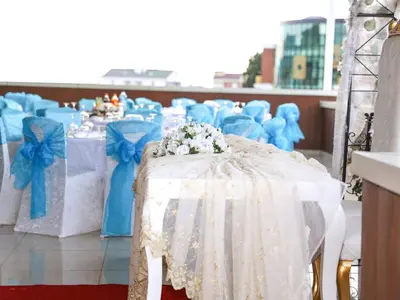 a row of tables and chairs with blue bows at Helenapolis OTEL in Yalova