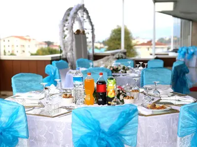 a set of tables with blue chairs and food at Helenapolis OTEL in Yalova