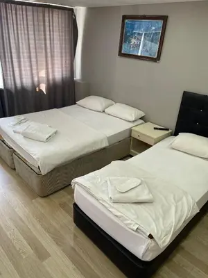 a room with two beds and a window at Simge in Istanbul