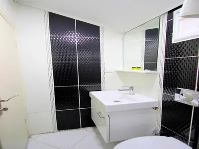 a bathroom with a toilet and a sink and a mirror at Simge in Istanbul