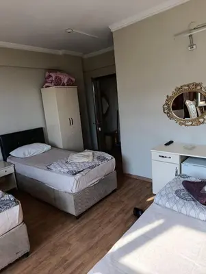 a room with two beds and a mirror on the wall at Simge in Istanbul