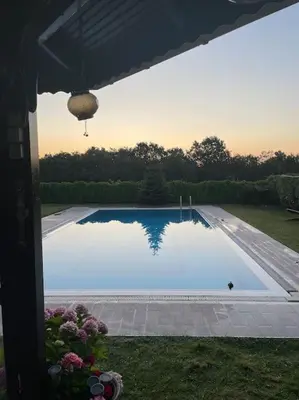 a swimming pool with a reflection in the water at Villa Elegance in Kocaeli