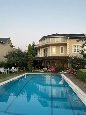 a house with a swimming pool in front of a house at Villa Elegance in Kocaeli