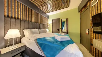 a bedroom with a large bed and a desk with a lamp at Wonder House Sultanahmet in Istanbul