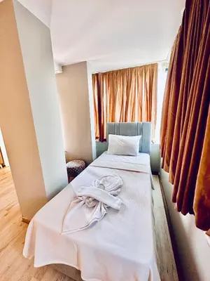 a bedroom with two beds with white sheets and a window at The Hera Gold Hotel in Istanbul