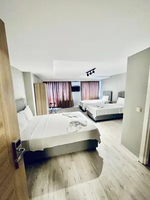 a hotel room with two beds and a door at The Hera Gold Hotel in Istanbul