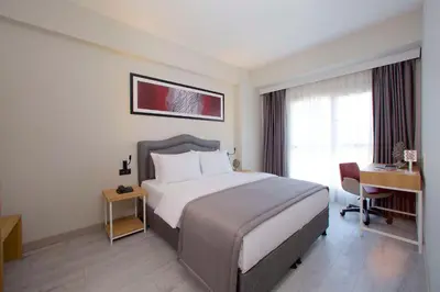 a hotel room with a large bed and a desk at Best Western Plus Hotel & Residences Istanbul in Istanbul