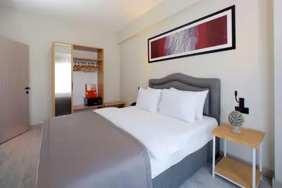 a bedroom with a large white bed and a table at Best Western Plus Hotel & Residences Istanbul in Istanbul