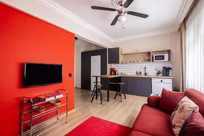 a living room with a red accent wall at AKA Home in Istanbul