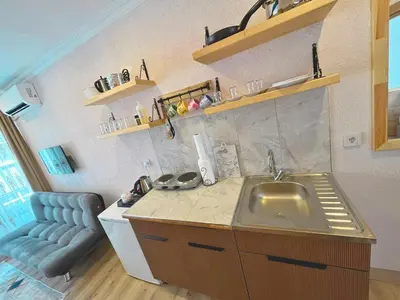 a kitchen with a sink and a couch in a room at Dila Apart Hotel in Istanbul