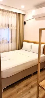 a bed in a room with a window at Dila Apart Hotel in Istanbul