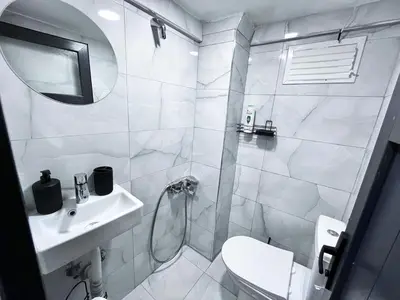 a white bathroom with a toilet and a sink at Bro Apartments Sultanahmet in Istanbul