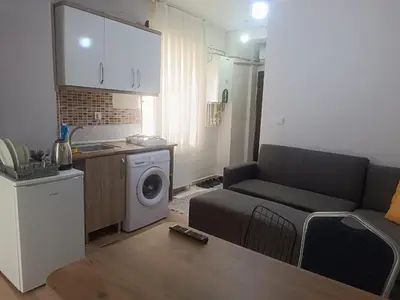 a living room with a couch and a washing machine at Taksim Dora Apart in Istanbul