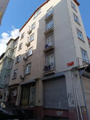 a tall building with windows and a garage at Taksim Dora Apart in Istanbul