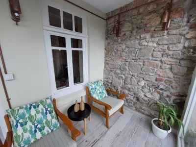 a room with two chairs and a brick wall at Stone Garden Apartment in the Heart of the City in Istanbul