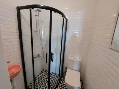 a bathroom with a shower and a toilet at Stone Garden Apartment in the Heart of the City in Istanbul