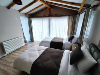 a hotel room with two beds and a couch at Cozy Duplex Next to Green Masjid in Yıldırım