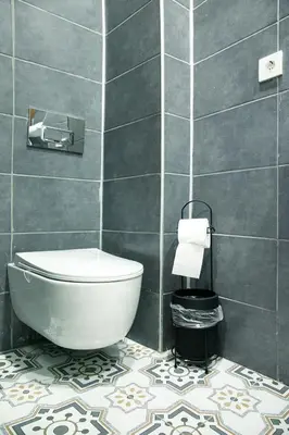 a bathroom with a toilet and a tile wall at Beans House Suite 8-26 in Istanbul