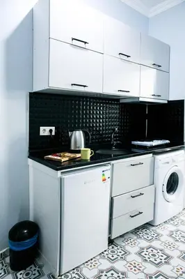 a kitchen with white cabinets and a washer and dryer at Beans House Suite 8-26 in Istanbul
