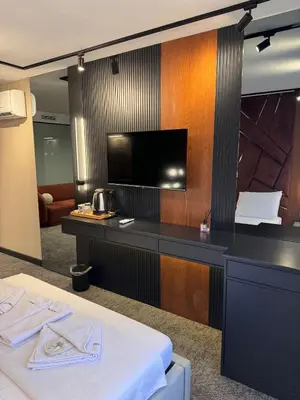 a hotel room with a bed and a flat screen tv at Zeytin Hotel in Istanbul